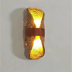 Wicker wall sconce with a warm glow on a plain background