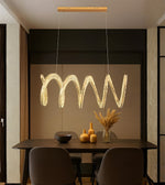 Sculpted wave crystal LED dining pendant light above a modern dining table interior