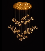 Luxury crystal blossom chandelier with gold branches installed in double height staircase area