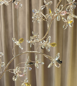 Luxury crystal blossom chandelier with gold branches installed in double height staircase area