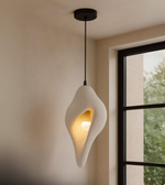 Contemporary pendant light in white, sculpted foam design with ambient lighting for modern interiors, cafes, and bedrooms.