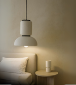 Nordic Glow all-white sculptural pendant light glowing warmly in minimal room.