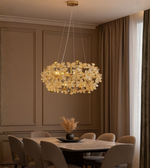 Florenza gold crystal floral chandelier glowing above elegant dining setup.