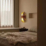 Decorative wall light fixture in a bedroom setting with soft lighting.