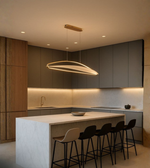 Aero Linear Pendant Light illuminating a modern kitchen with grey cabinetry and marble island.