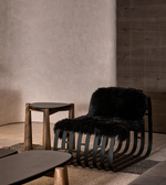 Daya Worldwide Noir Sculpt Lounge Chair in black fabric with smooth, modern design and curved armrests for stylish comfort.