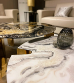 Marble coffee table set with sleek, modern design featuring white marble tops and black metal legs, by Daya Worldwide.
