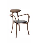 Elio wooden dining chair with a curved backrest and four legs, crafted from light wood for a modern dining room setting.