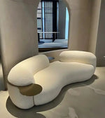 Daya Worldwide Cove Curve Sofa featuring a sleek, curved design with plush upholstery and modern style in a contemporary living room setting.