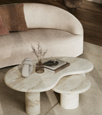 Marble nesting coffee tables with smooth pebble-shaped surfaces in a modern Daya Worldwide design.