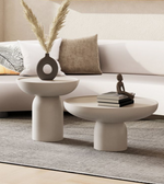 Set of two sculpted ceramic accent tables with textured finishes, ideal for stylish home decor and versatile living space accents.
