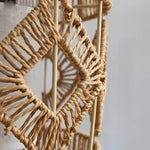 Close-up of handwoven natural fiber detailing on boho floor lamp
