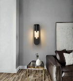 Modern wall sconce in a living room setting with a sofa and side table.