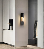 Modern wall sconce in a stylish interior setting with neutral colors.