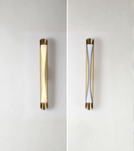 Two cylindrical wall lights with gold accents on a white background