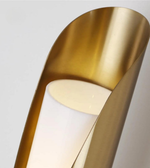 Gold lamp with a soft glow on a light gray background