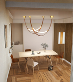 Modern dining room with a chandelier, table, and chairs.