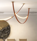 Modern ceiling light fixture with warm glow in a room setting