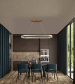 Modern kitchen with pendant light fixture, dining table, and chairs.