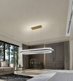 Modern chandelier hanging in a stylish bedroom with large windows and decor.