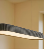 Modern pendant light with ribbed design on a beige wall background