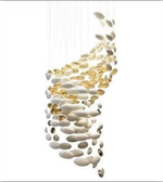 Decorative hanging light fixture with white and gold elements on a white background