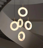 Modern pendant light with circular design on a dark background