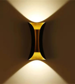 Gold wall sconce casting light on a wall