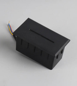 Black electronic component with wires on a gray background