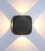 Modern wall light fixture on a white wall with geometric patterns