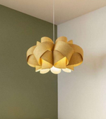 Yellow pendant light hanging between two walls with a neutral color scheme