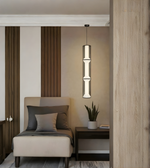 Modern interior with a pendant light, chair, and small table.