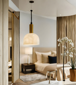 Modern bedroom with a bed, lamp, and decorative elements.