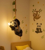Panda plush toy hanging from a rope on a wall with sloth and panda wall decals.