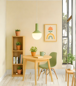 Modern dining area with wooden table, chairs, and bookshelf against a light yellow wall.