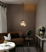 Modern living room with a brown sofa, round coffee table, and decorative elements.