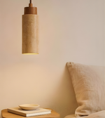 Pendant light fixture on a bedside table with a soft glow