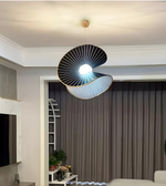Modern ceiling light fixture in a living room setting with neutral decor.