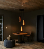 Modern dining area with wooden table, chairs, and pendant lights in a dimly lit room.