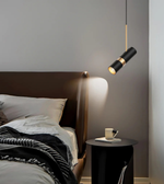 Modern bedroom with a bed, nightstand, and pendant light fixture.