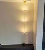 Modern pendant light fixture on a neutral wall