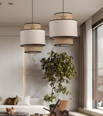 Modern living room with pendant lights, a plant, and a sofa.