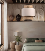 Modern bedroom with a pendant light, bed, and decorative items.