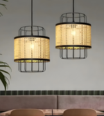 Two pendant lights with woven design and black metal frames hanging above a dining table.