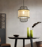 Modern pendant light hanging above a dining table with decorative elements.