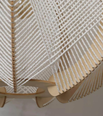 Close-up of a woven chair with a geometric pattern on a plain background