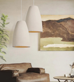 Modern living room with pendant lights, sofa, and wall art