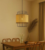 Dining room with a wicker pendant light, wooden table, and chairs.