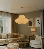 Cozy living room with beige sofa, armchair, and pendant light.