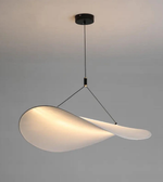 Modern pendant light with a white lampshade on a gray background